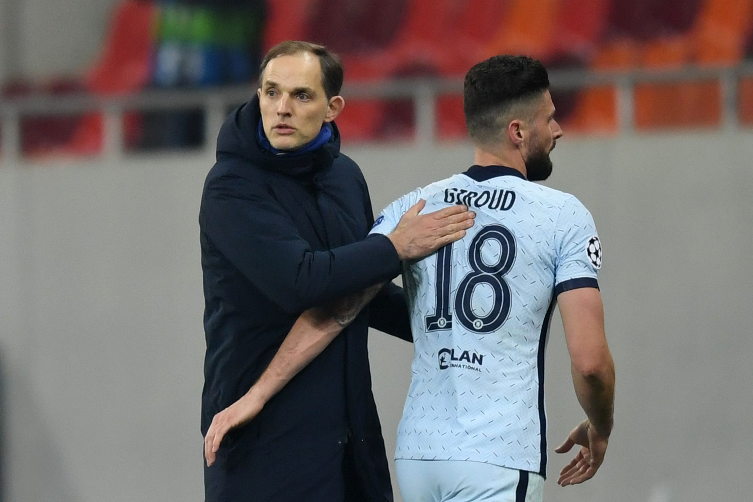 Thomas Tuchel (L) greets Chelsea's French striker Olivier Giroud during the UEFA Champions League round of 16 first leg football match between Club Atletico de Madrid and Chelsea.