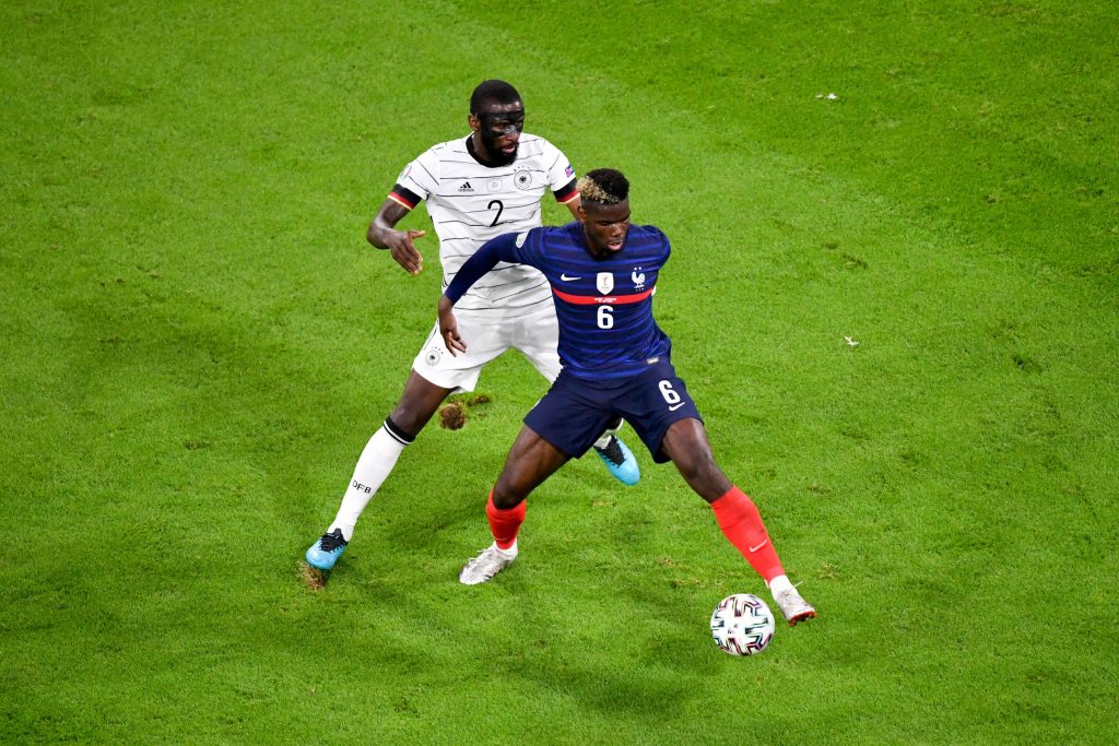 Antonio Rudiger of Chelsea and Germany vies for the ball with Paul Pogba of France and Manchester United.