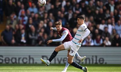 Aston Villa's Matty Cash eyes the ball as he fights for it with Chelsea's Kai Havertz.