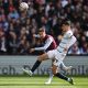 Aston Villa's Matty Cash eyes the ball as he fights for it with Chelsea's Kai Havertz.