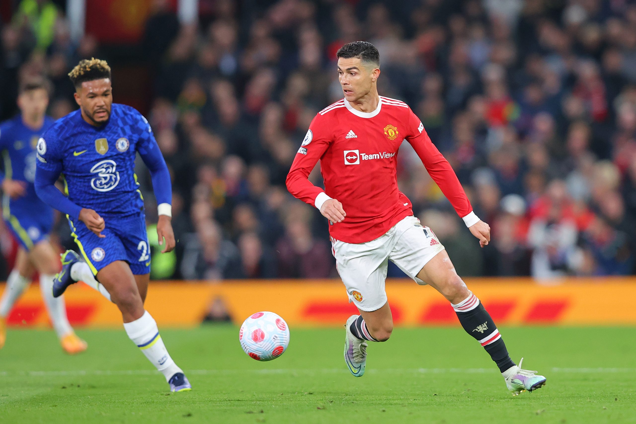 Cristiano Ronaldo of Manchester United runs with the ball from Reece James of Chelsea.