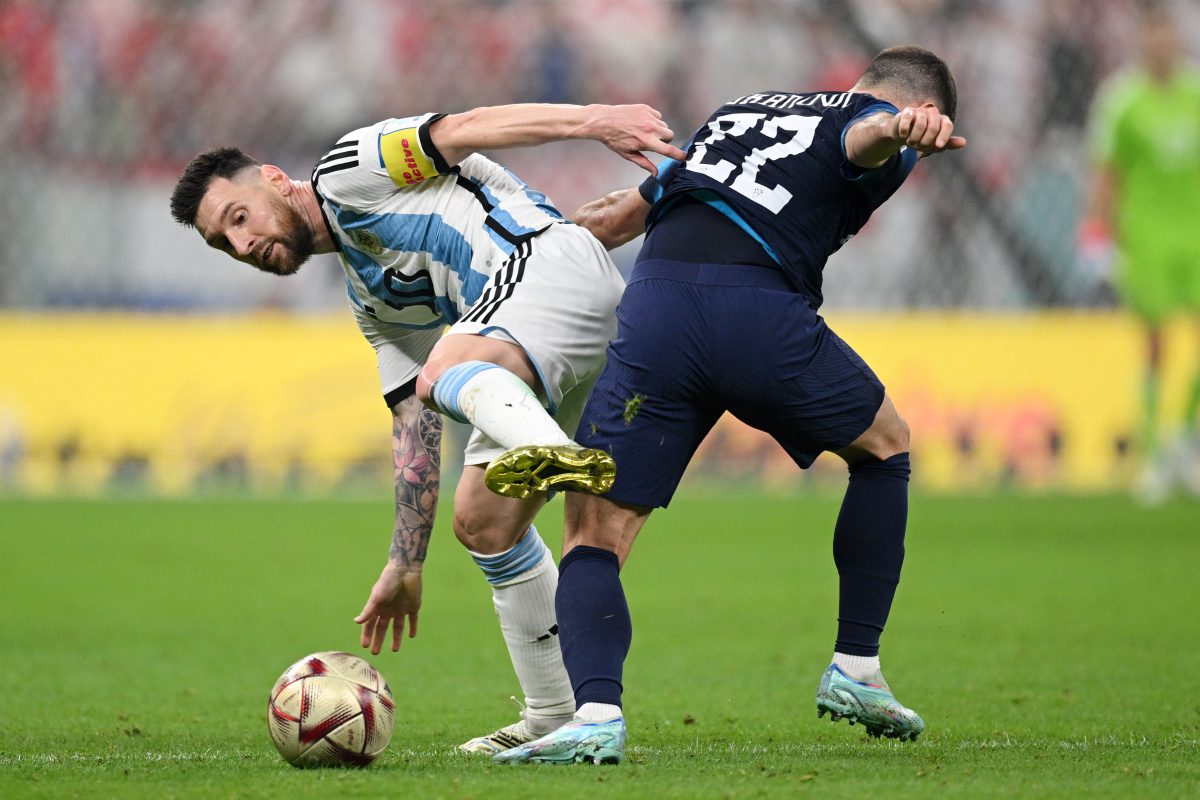 Lionel Messi of Argentina battles for possession with Josip Juranovic of Croatia. 