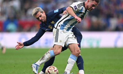 Antoine Griezmann of France with Alexis Mac Allister of Argentina at the 2022 FIFA World Cup final.