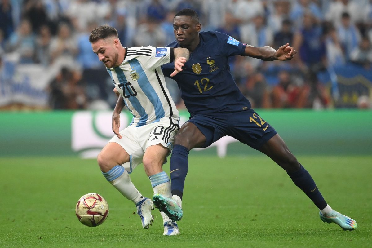 Argentina's midfielder #20 Alexis Mac Allister and France's forward #12 Randal Kolo Muani fight for the ball during the Qatar 2022 World Cup football final match between Argentina and France at Lusail Stadium in Lusail, north of Doha on December 18, 2022. (Photo by FRANCK FIFE / AFP) (Photo by FRANCK FIFE/AFP via Getty Images)