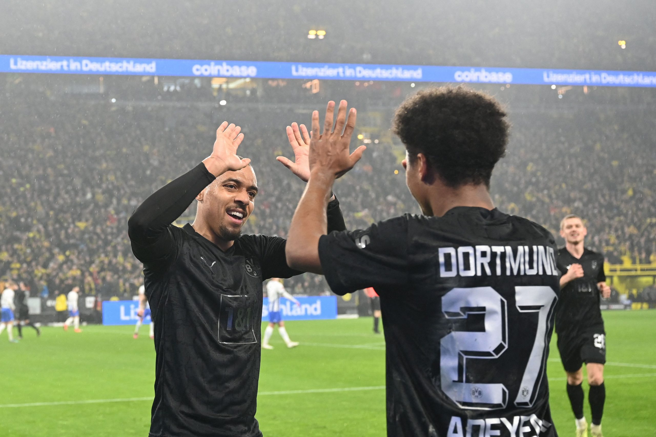 Dortmund's Karim Adeyemi celebrates with Donyell Malen.