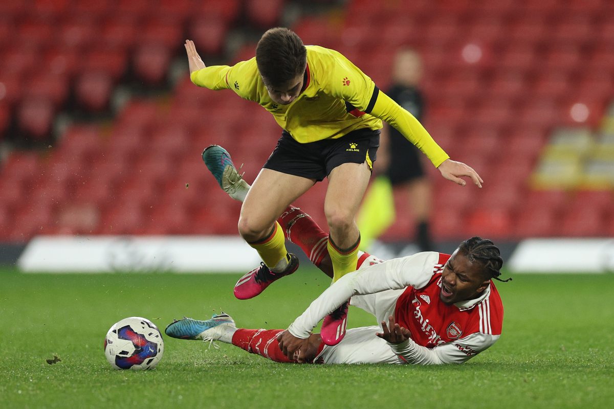 Omari Benjamin of Arsenal is tackled by Harry Amass of Watford. 